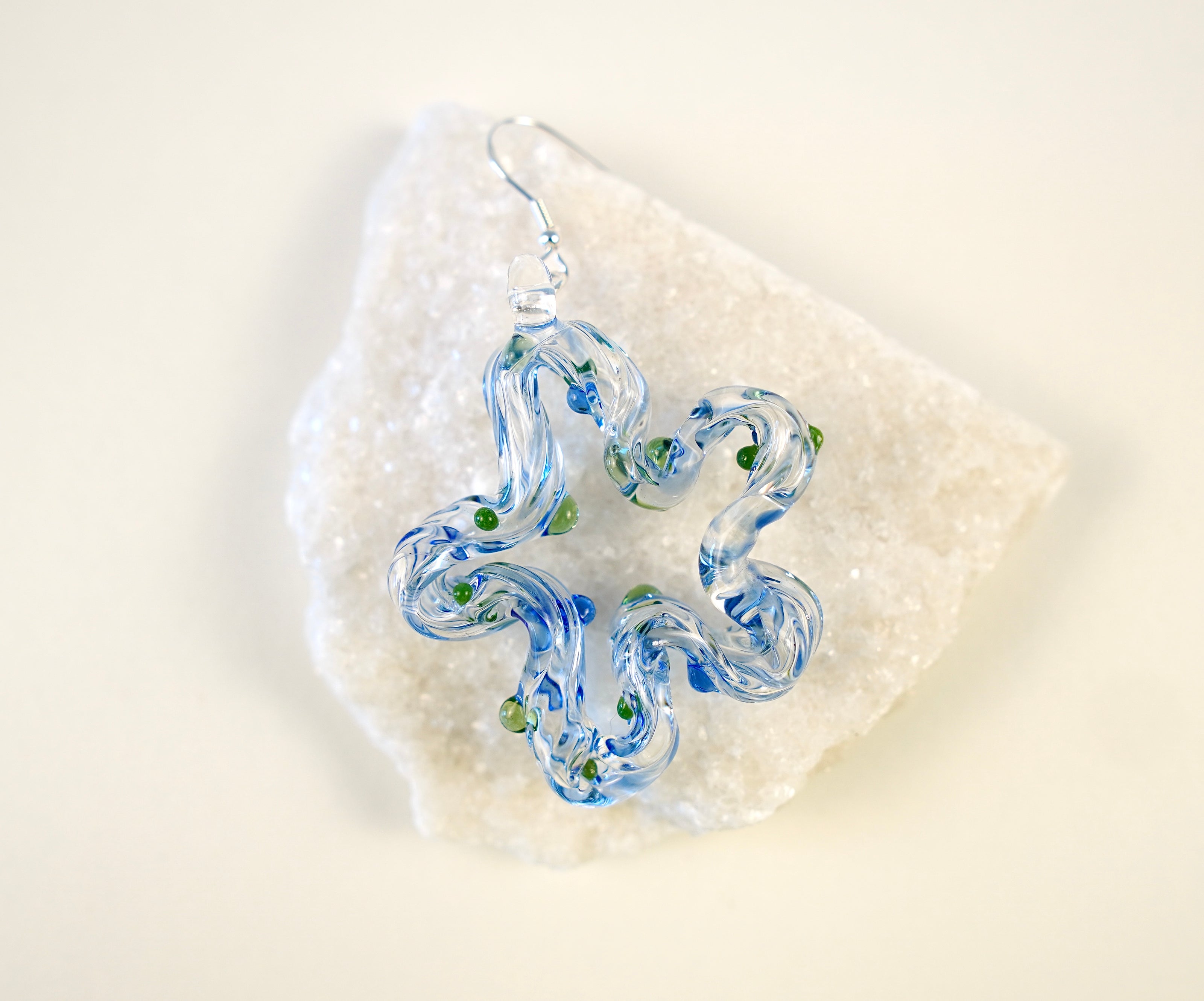 A flowing, ocean-inspired design in translucent blue with touches of green, hand-sculpted to echo the rhythm of waves and the freshness of sea breeze.